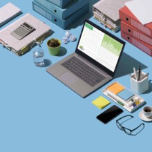 Financial report on a laptop screen, paperwork and office supplies on a desktop: business management and technology concept, blank copy space