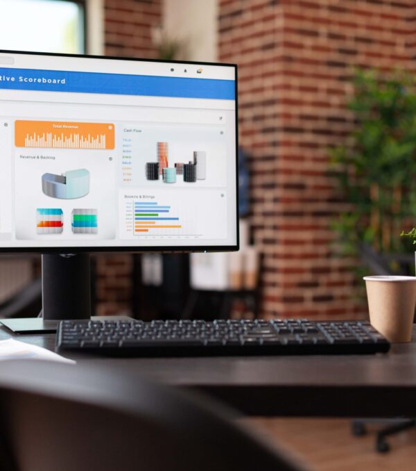Computer with financial company data on charts in office. Empty business space with economy analytics following rate trend on monitor to make investment for organization development.